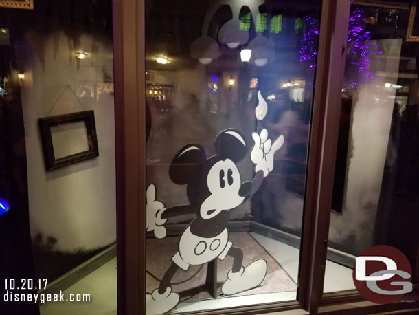 Some Buena Vista Street windows feature black and white Halloween inspired Mickey/Minnie displays.