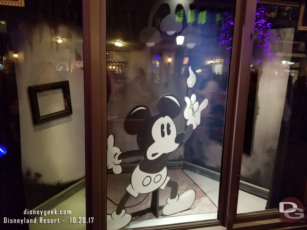 Some Buena Vista Street windows feature black and white Halloween inspired Mickey/Minnie displays.