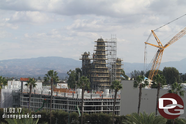 The Millennium Falcon show building with the mountains rising above it.