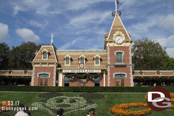 Garland up on the train station, but Halloween plantings still.