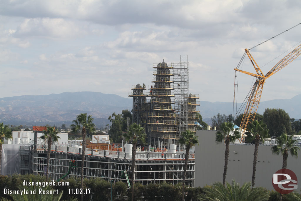 The Millennium Falcon show building with the mountains rising above it.