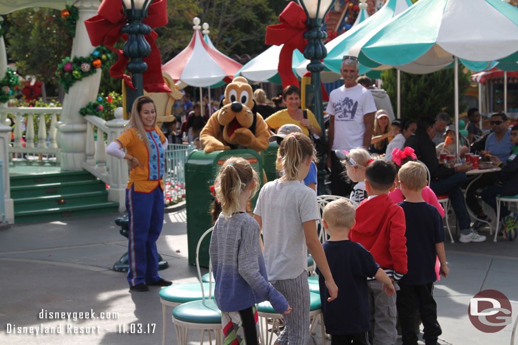 Pluto was leading a group of kids in a came of musical chairs.  He was supplying the beat.