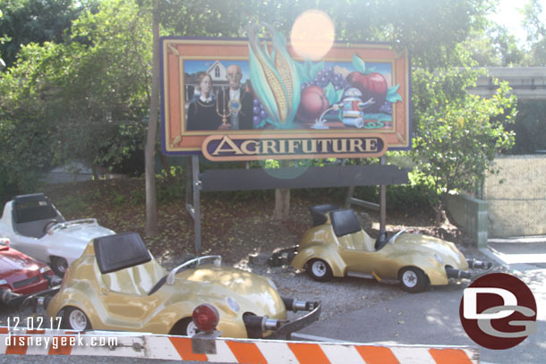 A handful of Autopia Cars parked backstage near the tracks.