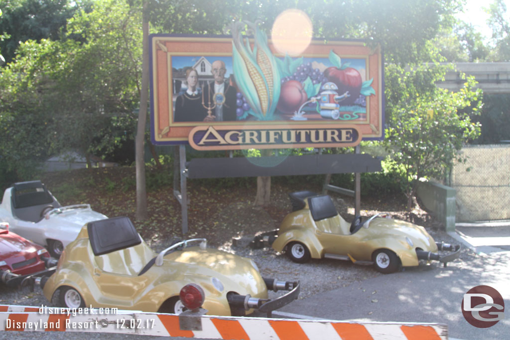 A handful of Autopia Cars parked backstage near the tracks.