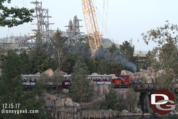A Disneyland Railroad train passing by.  It helps to convey the scale of the Star Wars project behind it.