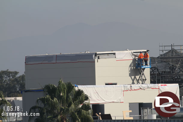 Crews working on the structures on the roof of the Battle Escape Building.  Could not tell if they were preparing it for the rain predicted for next week or if they were finishing it up.