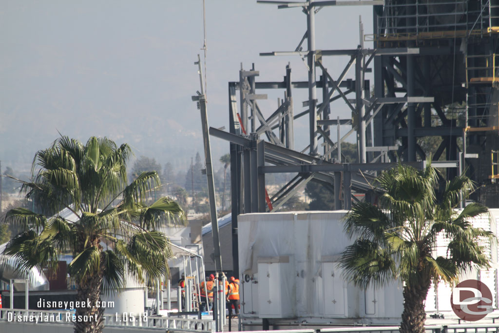 The crew guiding the piece into place.