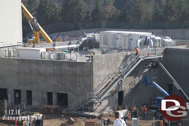 The exterior stairs on the concrete building look almost complete.