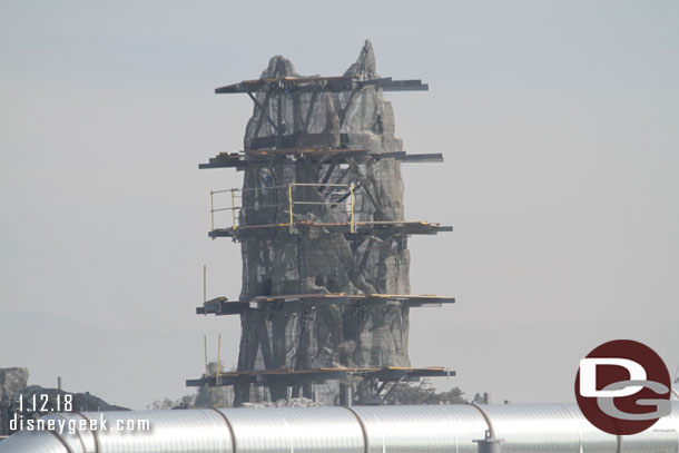 Further right the taller of the shorter peaks has most of its wire mesh installed so you can see the shape and scaffolding is going up.