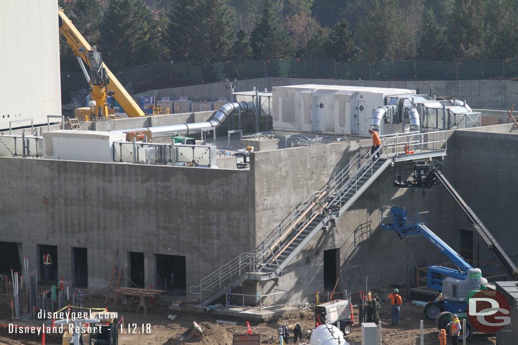 The exterior stairs on the concrete building look almost complete.