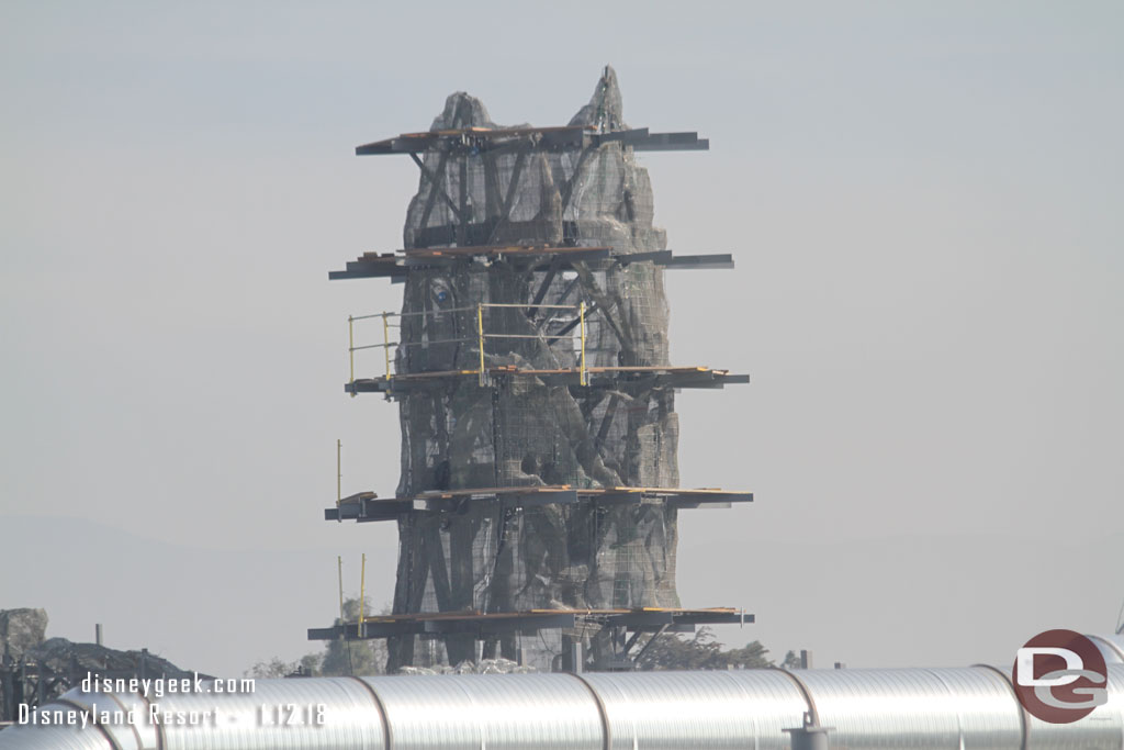 Further right the taller of the shorter peaks has most of its wire mesh installed so you can see the shape and scaffolding is going up.