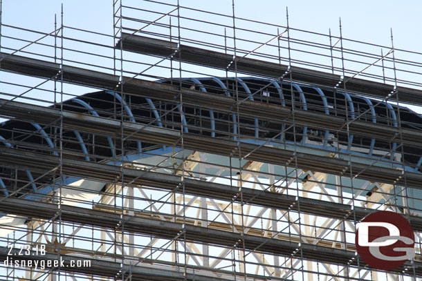 The tubes on the large hill are being enclosed behind the scaffolding.