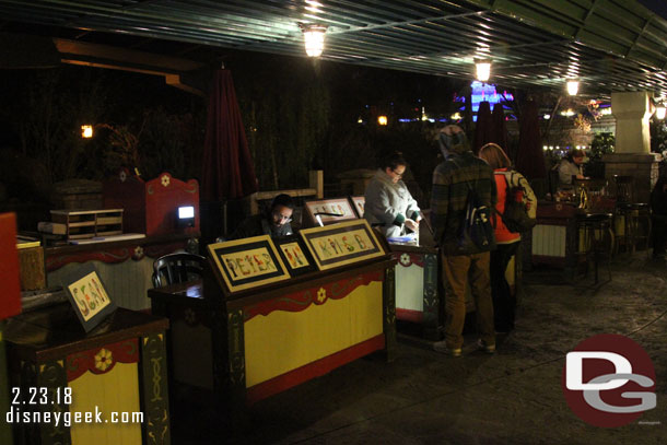 The art tables/kiosk have moved to the former smoking area under the monorail beam.