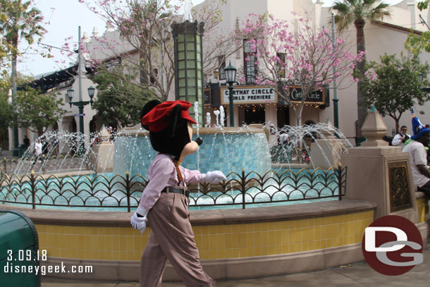 I was taking a picture of the fountain and Mickey strolled through it.