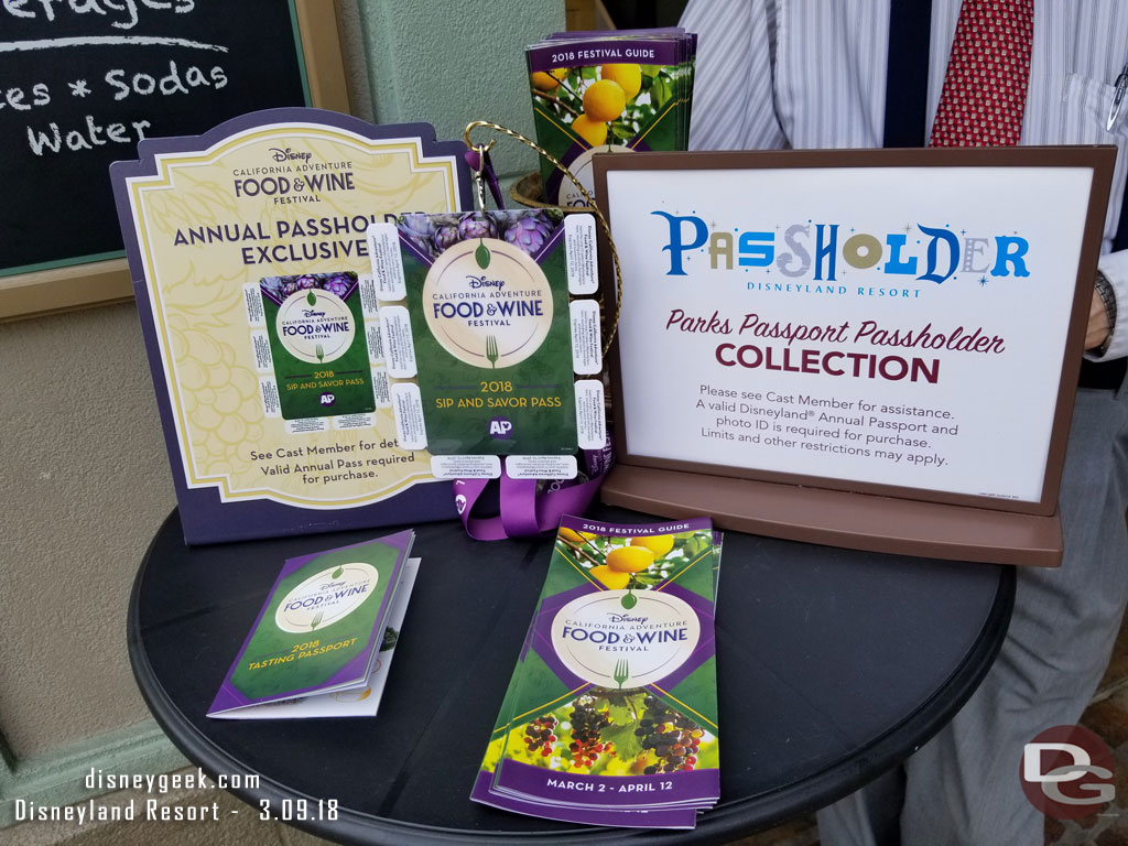 A table on Buena Vista Street advertising Food and Wine Festival Annual Passholder items.