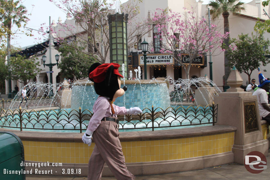 I was taking a picture of the fountain and Mickey strolled through it.