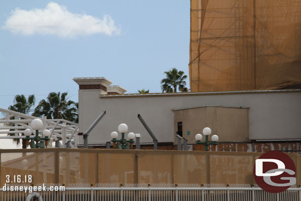 A steel structure that will support one of the entrance decorations is slowly rising above the fence.