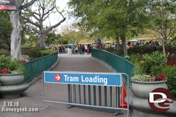 Tram loading signs directing you to the side nearest the park.