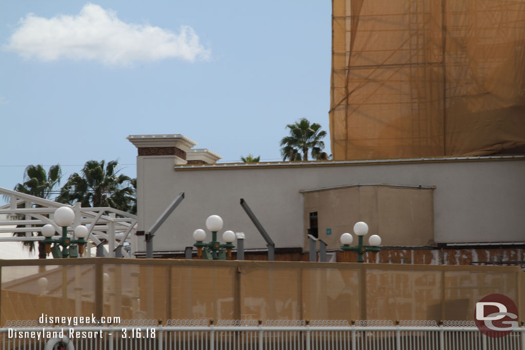 A steel structure that will support one of the entrance decorations is slowly rising above the fence.