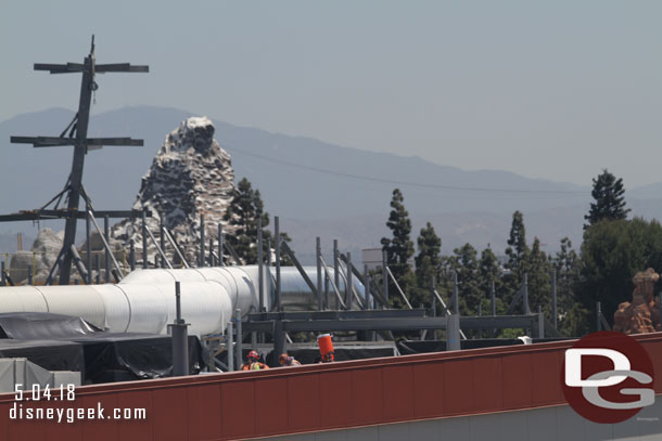 A crew working on the structure on the roof of the Battle Escape attraction.