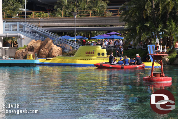 Walking by the sub lagoon it appears one of the subs is stuck just past the dock, near the track switch for the spur line.  Disneyland emergency services cast members department were evacuating guests via raft.