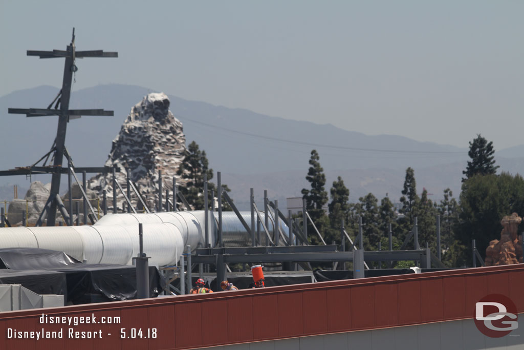 A crew working on the structure on the roof of the Battle Escape attraction.