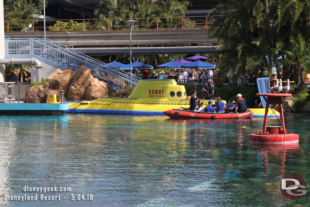 Walking by the sub lagoon it appears one of the subs is stuck just past the dock, near the track switch for the spur line.  Disneyland emergency services cast members department were evacuating guests via raft.