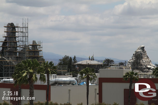 A crew working on the roof of a structure.