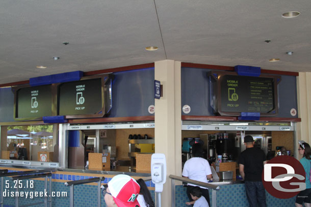 Mobile Ordering is being rolled out at the Disneyland Resort. As of Friday it was available only to Annual Passholders and at 15 locations in the two parks.  Here is a look at the Tomorrowland Terrace pick up windows.  Four of Ten were set up for Mobile Order Pick Up.