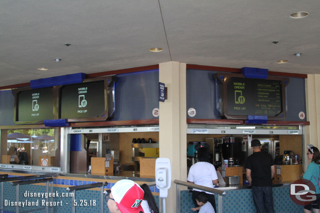 Mobile Ordering is being rolled out at the Disneyland Resort. As of Friday it was available only to Annual Passholders and at 15 locations in the two parks.  Here is a look at the Tomorrowland Terrace pick up windows.  Four of Ten were set up for Mobile Order Pick Up.