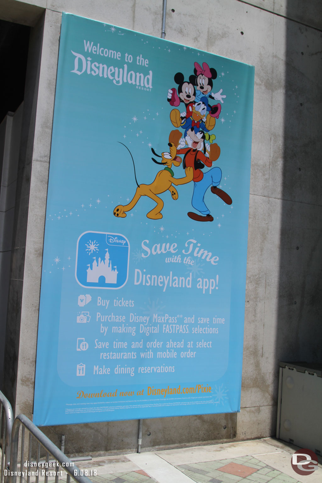 A sign for the Disneyland App as you near the security check point.