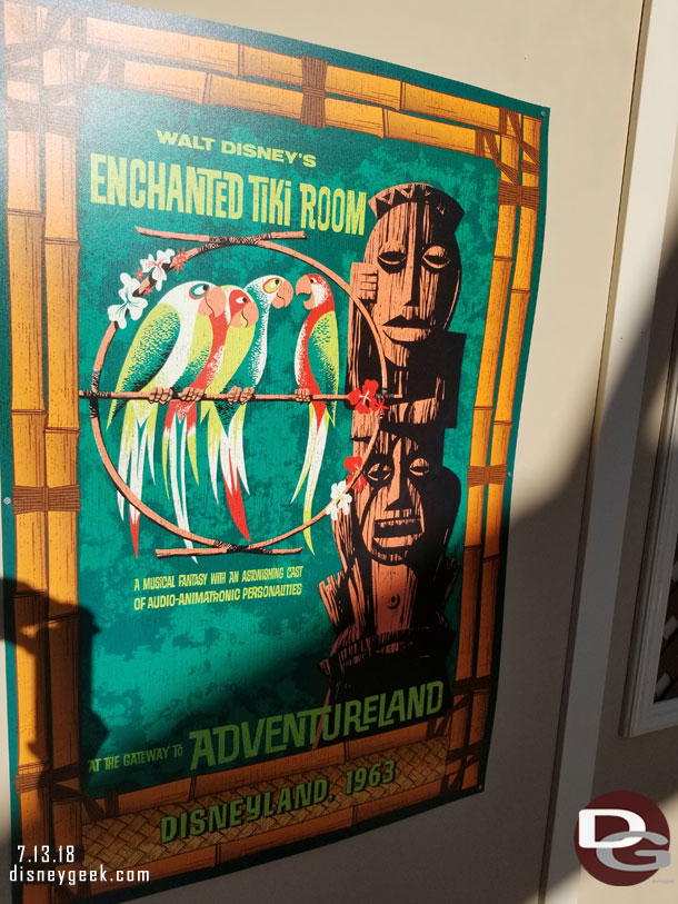 On the wall are Enchanted Tiki Room posters.