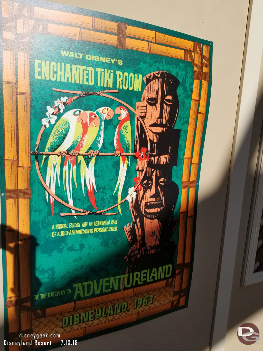 On the wall are Enchanted Tiki Room posters.