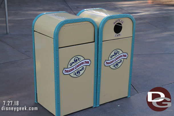 Some of the Paradise Gardens Park trash cans have their new stickers.