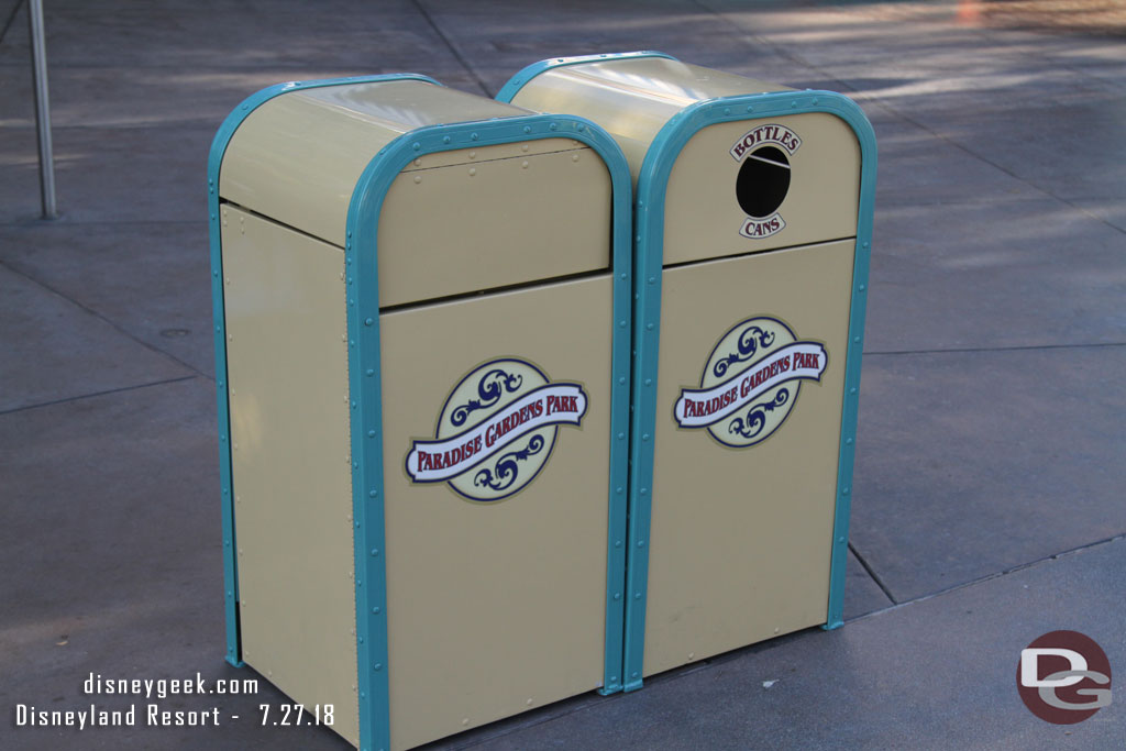 Some of the Paradise Gardens Park trash cans have their new stickers.