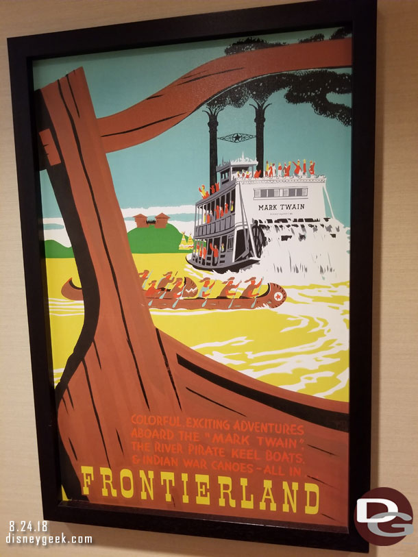 Frontierland attraction posters near the restrooms.