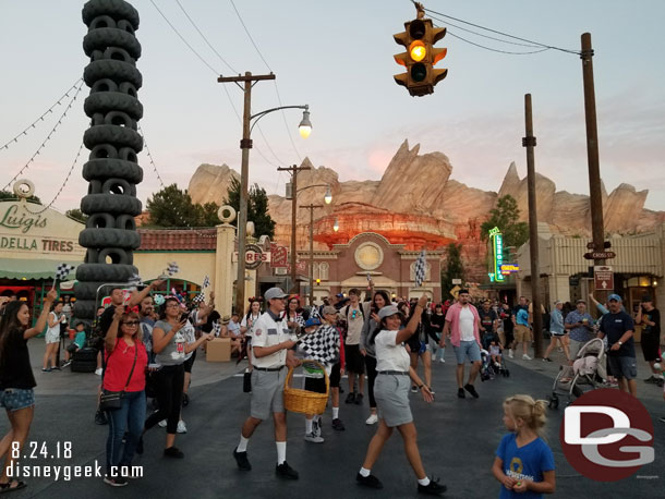 I was in the area for the lights to come on this evening in Cars Land.  Cast members recruited guests to dance around with flags as the song played and lights came on.