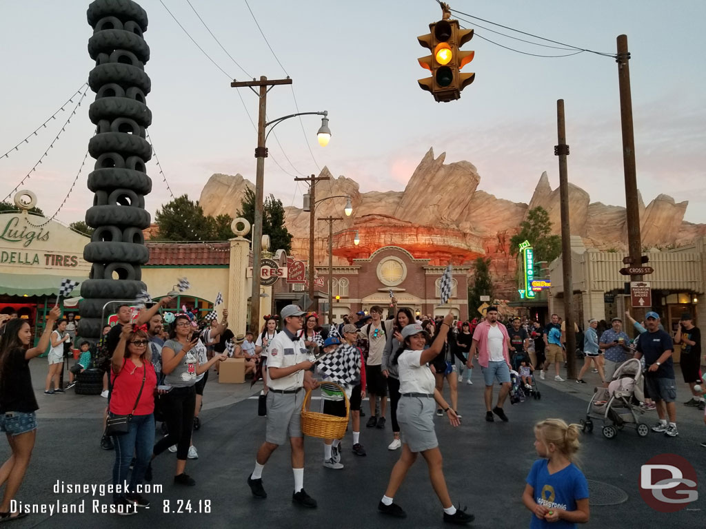 I was in the area for the lights to come on this evening in Cars Land.  Cast members recruited guests to dance around with flags as the song played and lights came on.