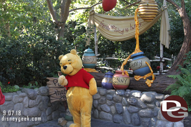 Winnie the Pooh greeting guests.