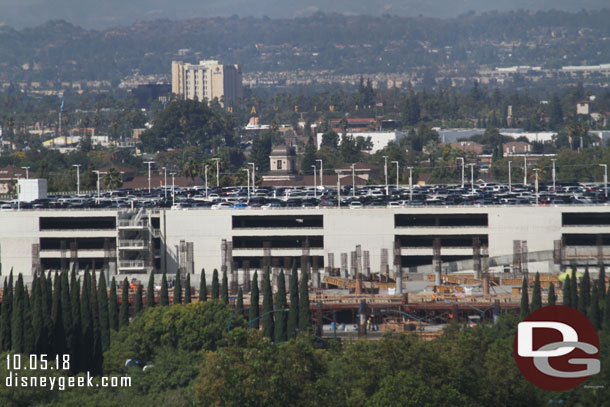 The new parking structure is starting to rise above the tree line.