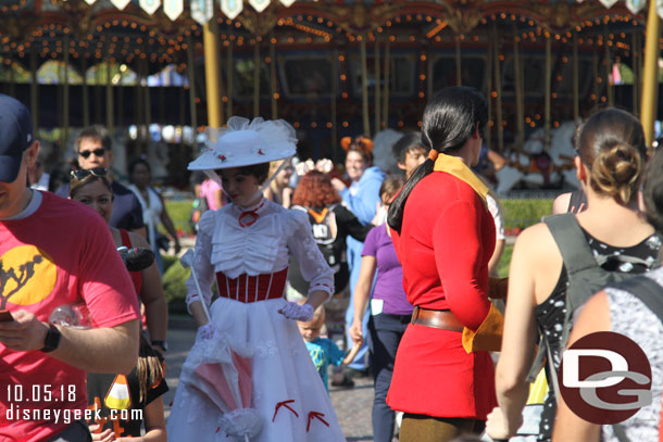 Mary Poppins and Gaston crossing paths in Fantasyland.