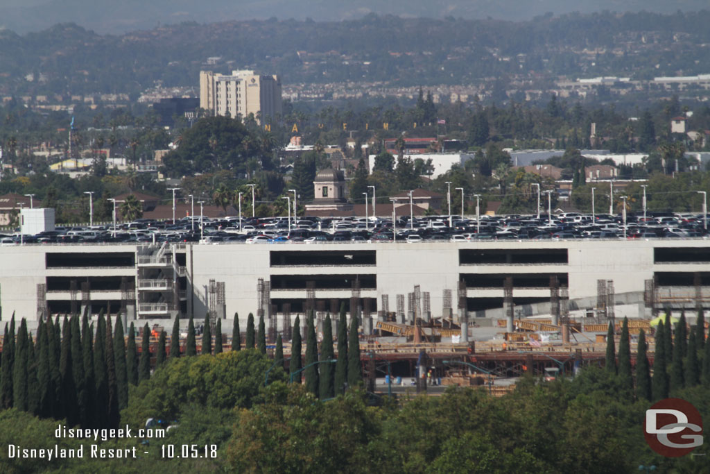 The new parking structure is starting to rise above the tree line.