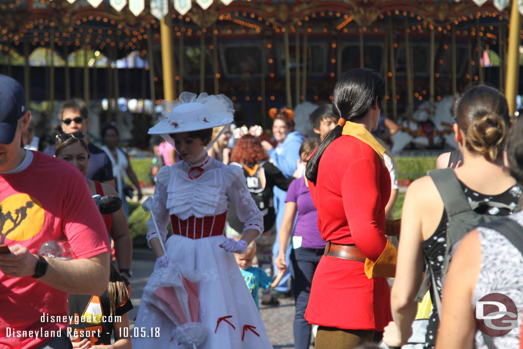 Mary Poppins and Gaston crossing paths in Fantasyland.