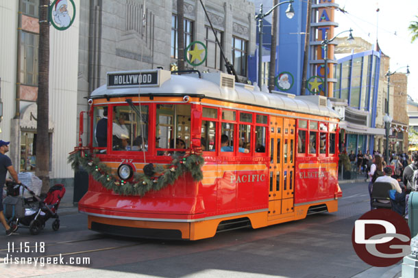 A red car making its way up Hollywood Blvd