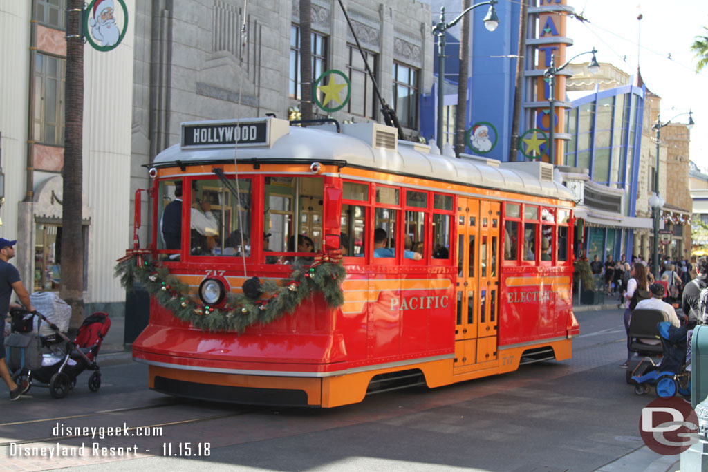 A red car making its way up Hollywood Blvd