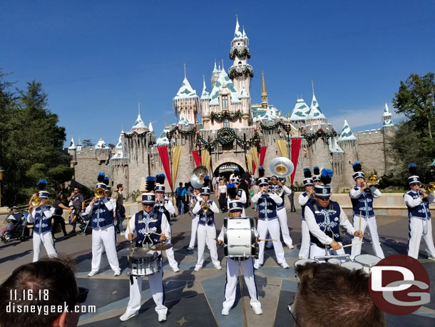 The Disneyland Band performing a Christmas set in front of Sleeping Beauty Castle.