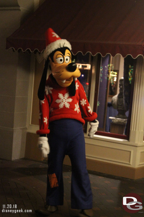 Goofy taking pictures with guests in Town Square.