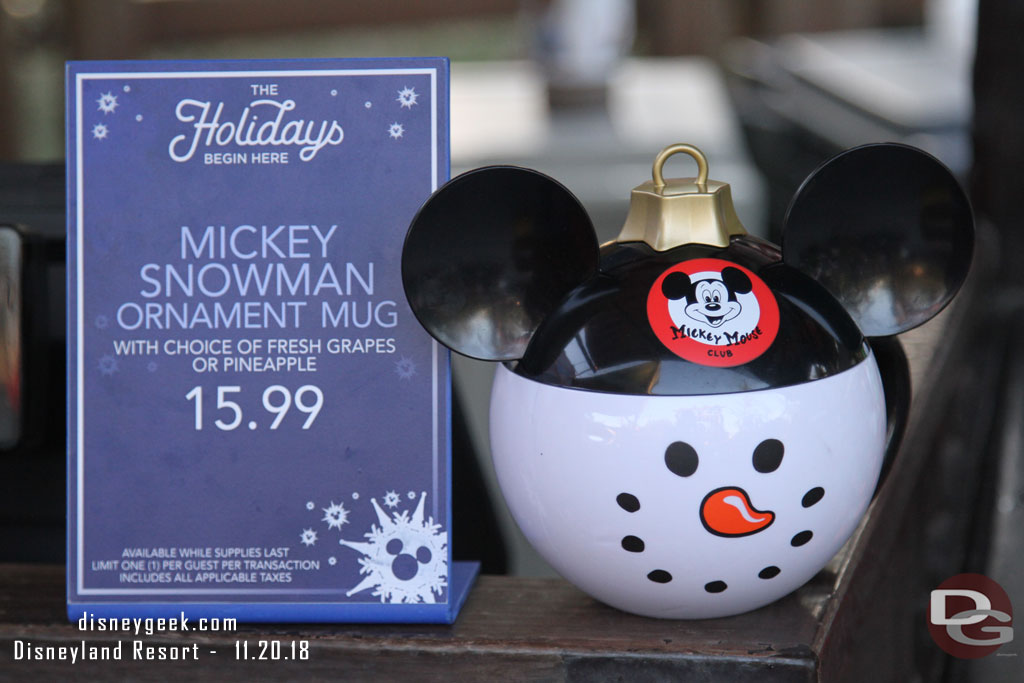 Mickey Snowman Ornament Mugs are available at several locations with various items inside.  This is at Fillmores.