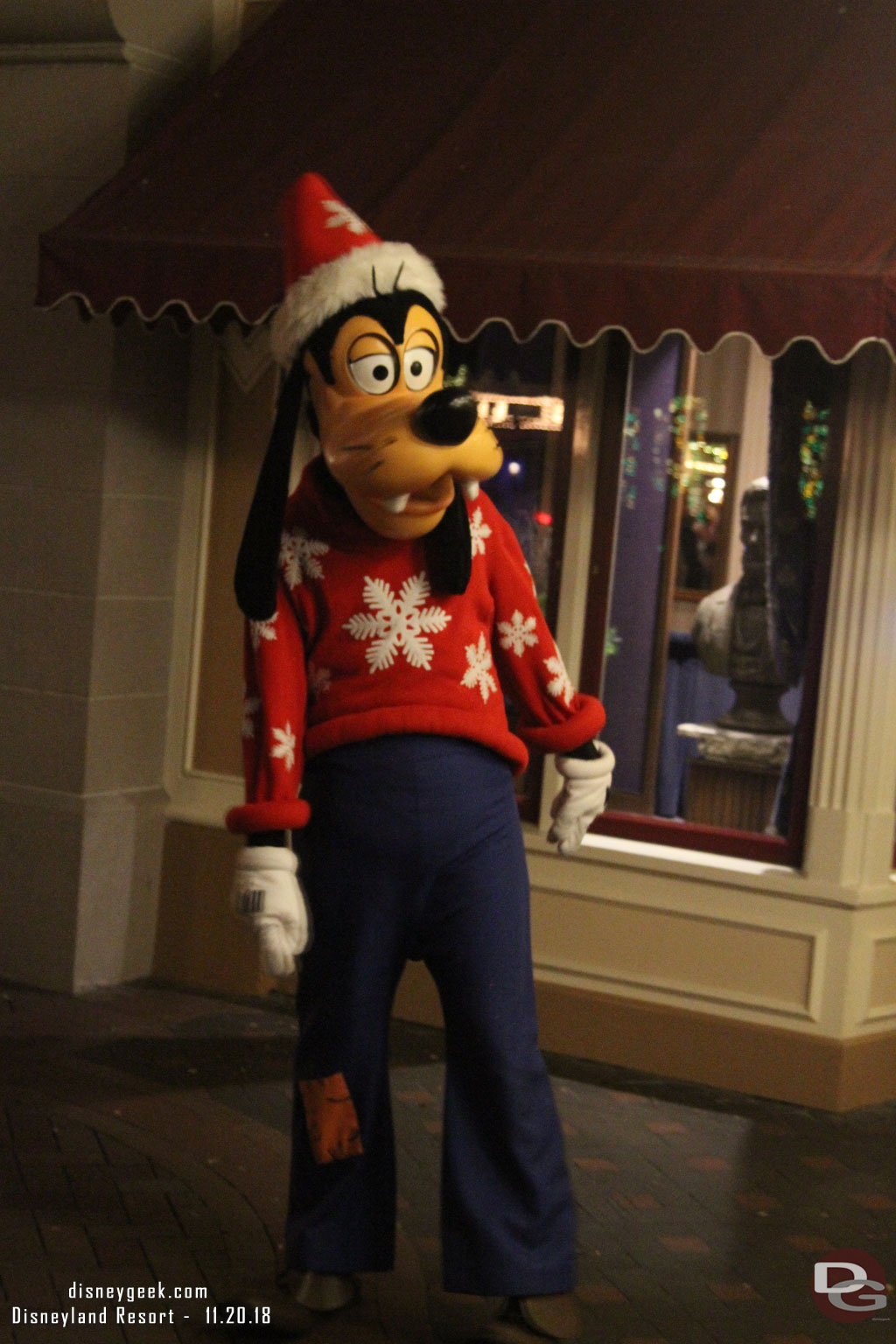 Goofy taking pictures with guests in Town Square.