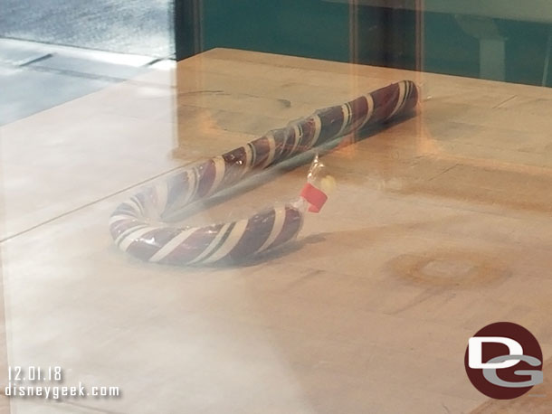 A finished candy cane on display in the Trolley Treats window.